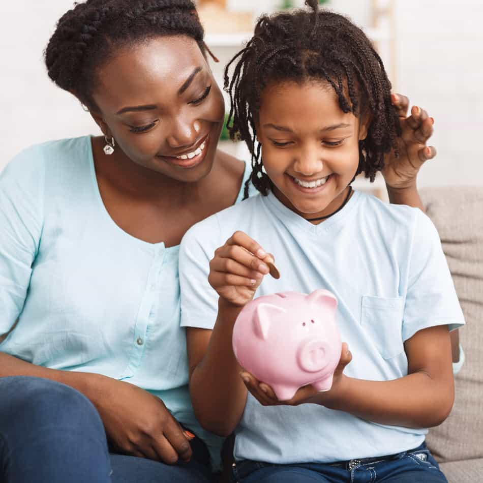 Mother with her kid and piggy bank.