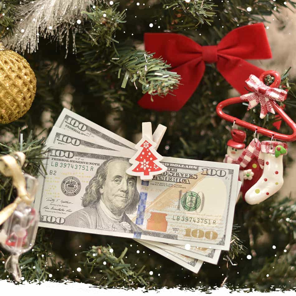 Christmas tree with one hundred dollar bills on it.